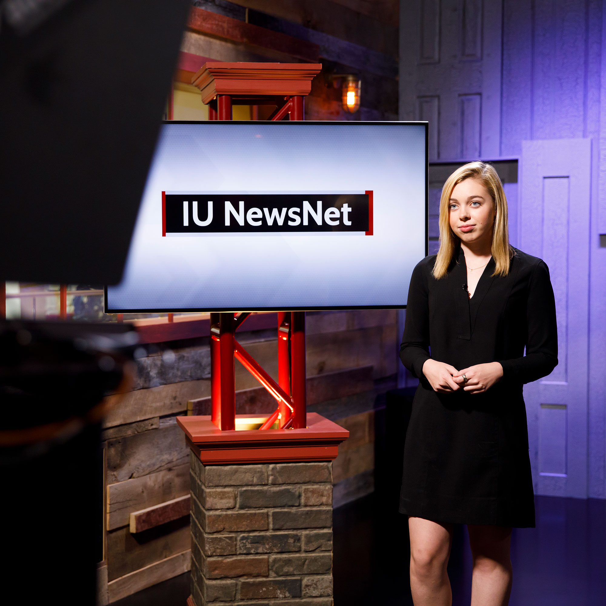 Mary Kate Hamilton in front of a screen that says "IU NewsNet"