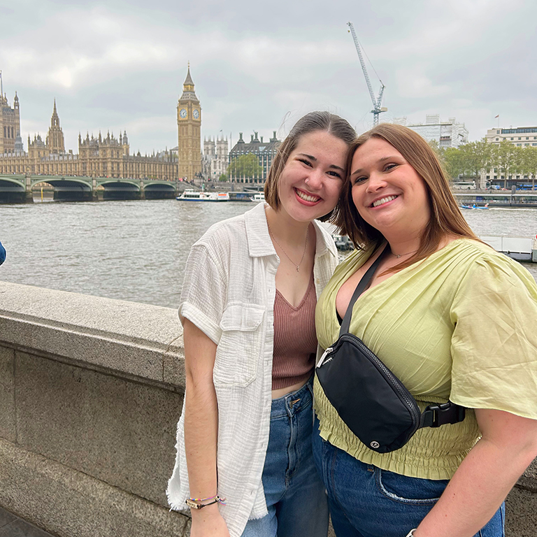 Two people pose in London with Big Ben in the background.